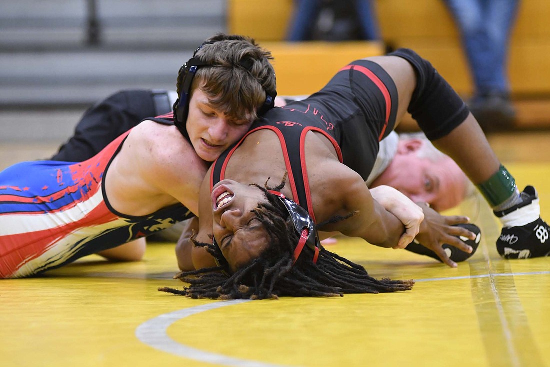 Sylas Wenk of Jay County High School puts pressure on North Central’s Ethan Smith during the second period of their match Friday in the Battle in the Bear Den hosted by Monroe Central. Wenk attacked Smith with ankle picks for a pin in 2 minutes, 32 seconds, and finished 3-0 in his contested matches. (The Commercial Review/Ray Cooney)