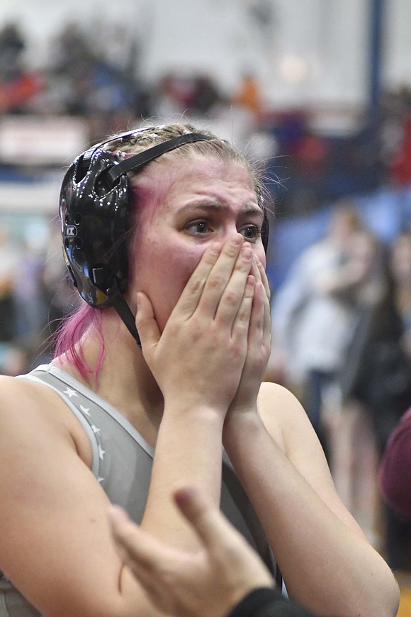 Lina Lingo of Jay County High School clasps her hands over her face after winning the 135-pound opening match over No. 9  Klaire Redwine on Jan. 12 during the Indiana High School Girls Wrestling state finals at Kokomo to clinch her first state medal. (The Commercial Review/Andrew Balko)