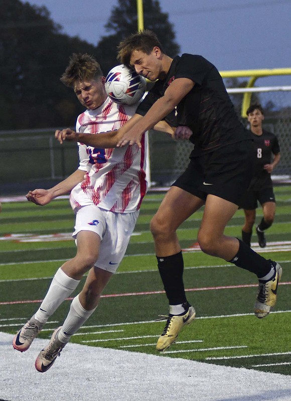 Jay County High School’s Blake Collins battles with Eastbrook’s Graeson Secrest to win a header during the IHSAA Class 2A Sectional 23 championship on Oct. 12. The Patriots claimed their second title in three years after nailing 4-of-5 penalty kicks. (The Commercial Review/Ray Cooney)