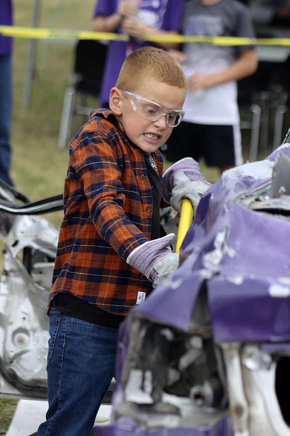 JT Steinbrunner, 6, takes a whack at a vehicle during Holy Cross Family of Parishes’ tailgate Sept. 6 prior to the football game at Barrenbrugge Athletic Park in Fort Recovery. (The Commercial Review/Bailey Cline)