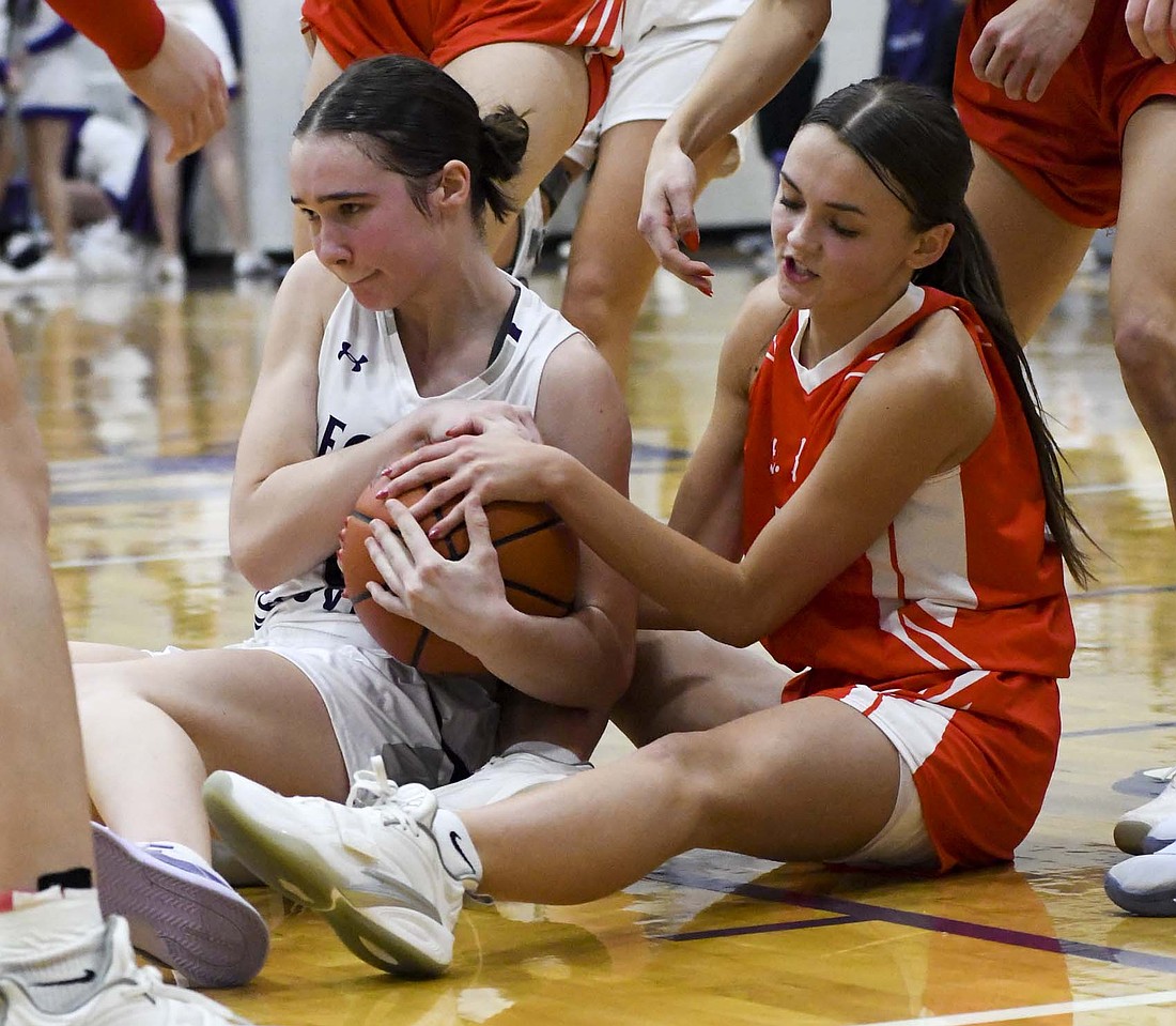 Fort Recovery High School sophomore Cameron Muhlenkamp fights with St. Henry’s Addy Homan for a loose ball during Monday’s 53-36 defeat. FRHS previously lost to St. Henry 44-42 on Dec. 5. (The Commercial Review/Andrew Balko)