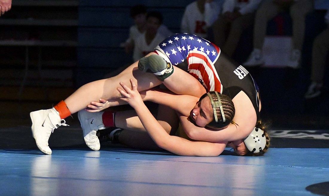 No. 1 Mallory Winner of JCHS hits No. 2 Rhaigyn Trenary of Eastside with a cradle in attempt to work her to the mat during the 155-pound state title match at Kokomo High School on Jan. 12. Winner beat Trenary 6-0 to claim her third consecutive state championship. (The Commercial Review/Andrew Balko)