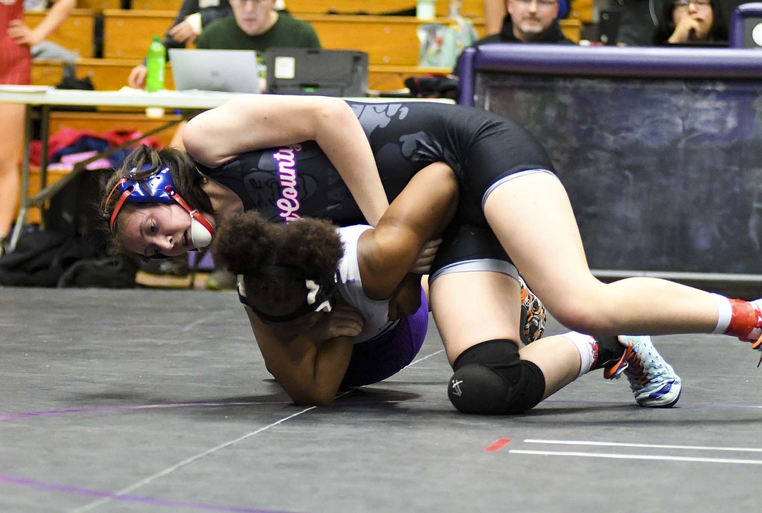 Madison Gage runs a double-wrist bar on Amaya Stoudmire of Muncie Central in the 155-pound opener. Gage pinned Stoudmire en route to her first regional berth and avenging an early season loss to Stoudmire in the process. Crawford, Gage, Ruble and Willis will be joined by six more Patriots at the regional on Jan. 10. (The Commercial Review/Andrew Balko)