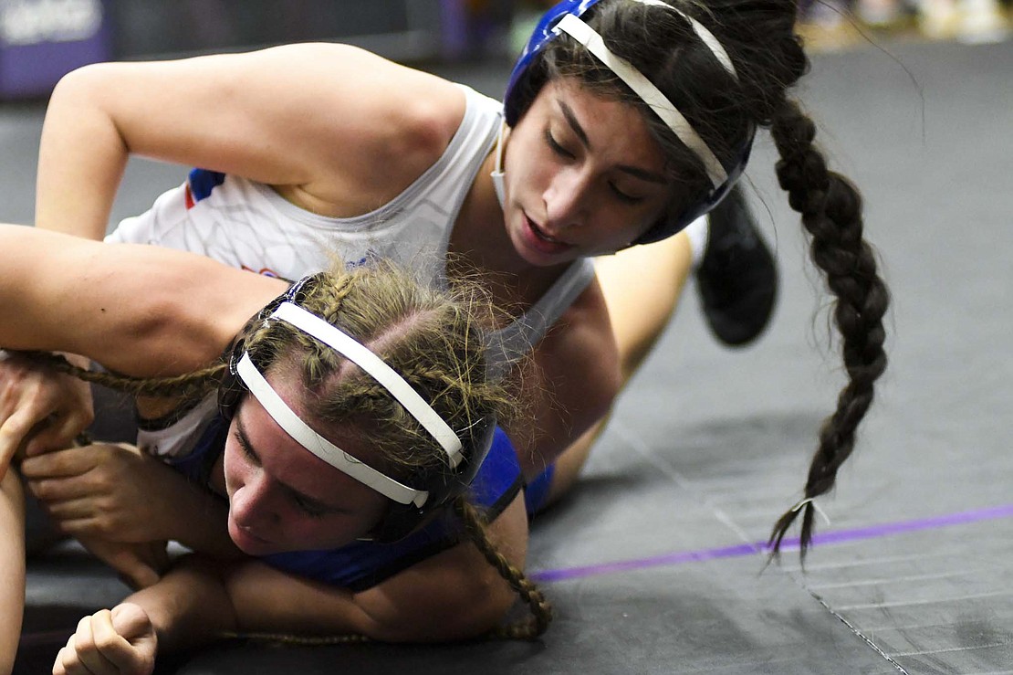 Jay County’s No. 11 Tatianna Willis tries to roll back the wrist of Hamilton Southeastern’s No. 14 Ella Shults in the 110-pound championship match in the inaugural IHSAA Sectional 10 hosted by Muncie Central on Friday. Willis built a 10-1 advantage before pinning Shults in the third period to secure her first sectional championship. Freshmen Brenna Ruble (120) and No. 5 Amara Crawford (190) also got their first sectional titles Friday. (The Commercial Review/Andrew Balko)