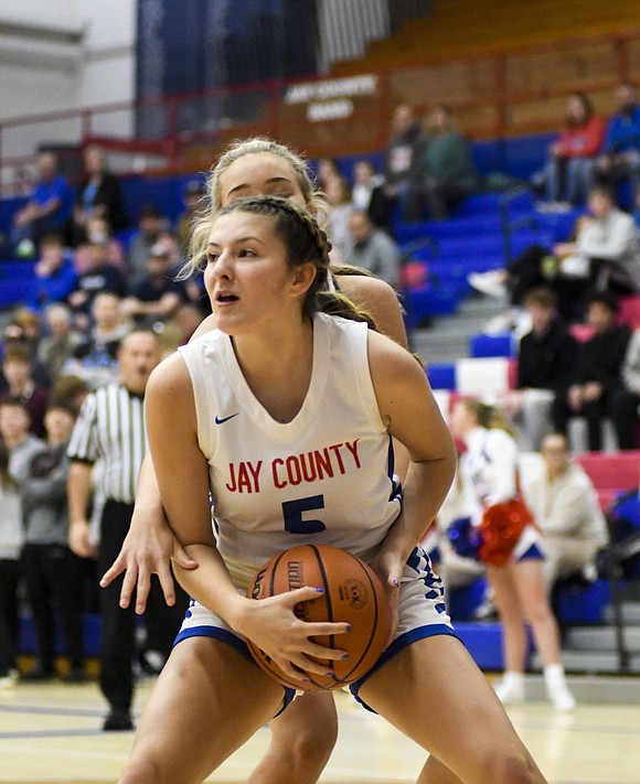 Jay County High School’s Alexis Sibray gathers the ball in the post while Pendleton Heights’ Emma Roberts tries to poke the ball away from behind. The Patriots struggled to defend the Arabians and take care of the ball, resulting in their first 48-point loss or worse since the 2018-19 season. (The Commercial Review/Andrew Balko)