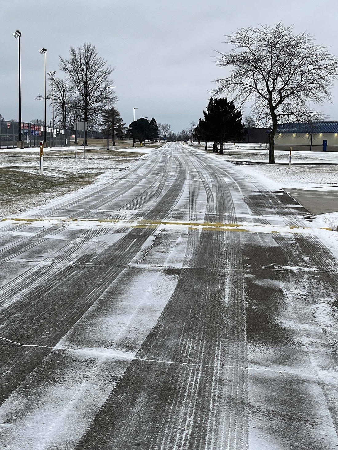 After initial forecasts had called for as much as 9 inches of snow beginning Sunday, Portland residents woke up Monday to just a dusting this morning as the storm predominantly stayed further south. Pictured, light snow dusts the driveway Monday morning at Jay County Junior-Senior High School. A winter weather advisory was lifted mid-morning Monday and there is no additional snow in the forecast until Friday. (The Commercial Review/Ray Cooney)