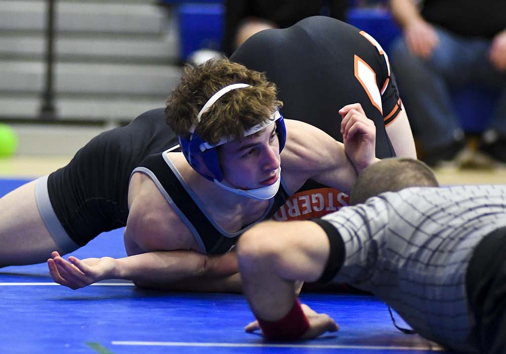 A.J. Heskett of Jay County High School pins Coldwater's Trent Westgerdes during their 132-pound match Tuesday. Heskett's win put the Patriots up by four en route to a 42-33 victory after they had trailed by 21 through the first seven matches. (The Commercial Review/Ray Cooney)