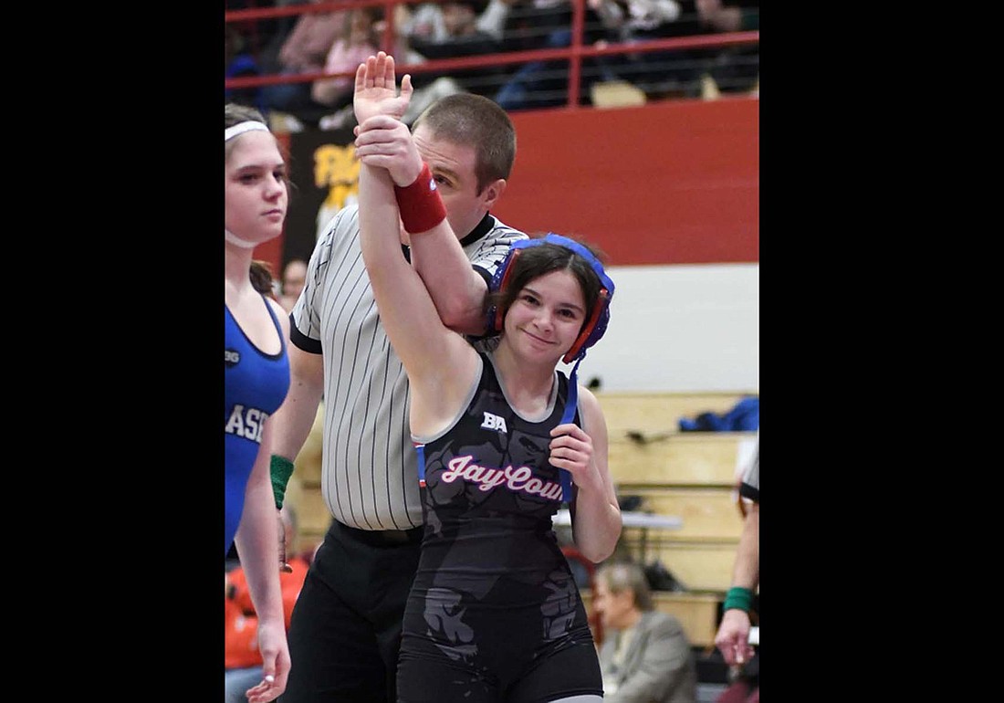 The Jay County High School girls wrestling team claimed second place out of 54 teams at the IHSAA Regional 3 hosted by Alexandria-Monroe on Friday, with five Patriots moving on to the state finals at Corteva Coliseum at Indiana State Fairgrounds on Jan. 17. At left, No. 5 Katie Rowles grins after winning her 100-pound ticket round match to make it back to the state tournament for the first time since 2023. (The Commercial Review/Andrew Balko)