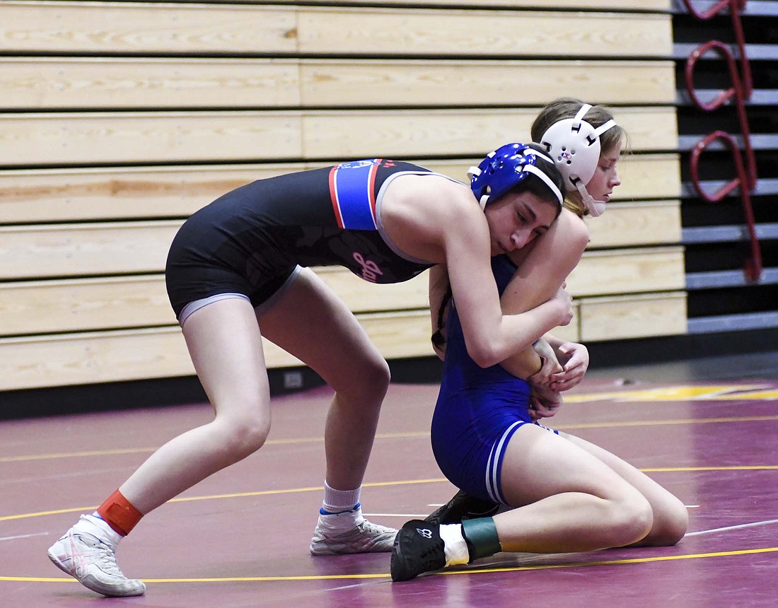 No. 11 Tatianna Willis of Jay County High School wraps up Alexa Moore of Bishop Chatard in the ticket round of the regional meet on Jan. 10 at Alexandria-Monroe. Willis will have to take on No. 4 Brooke Fuller in the 110-pound opener at the state finals on Friday. (The Commercial Review/Andrew Balko)