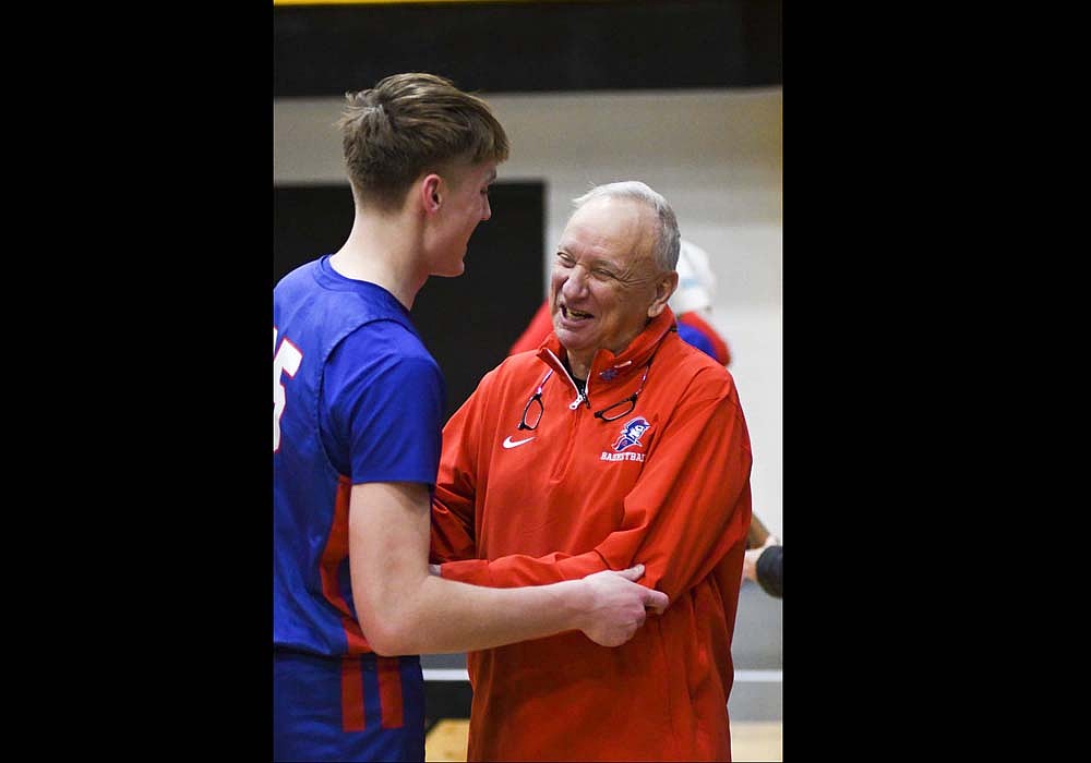 Jay County High School basketball coach Jerry Bomholt grins with junior forward Gradin Swoveland following the Patriots’ 61-14 win over South Adams in the opening round of the ACAC tournament Tuesday that earned him his 600th career win. “Coach, you finally hit 600. I love you. It’s an awesome milestone,” Swoveland said to Bomholt before the two embraced each other. (The Commercial Review/Andrew Balko)