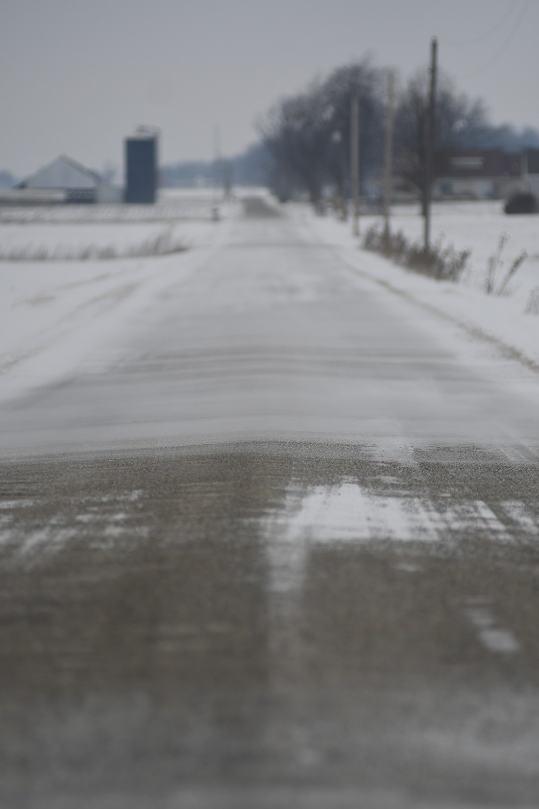 Snow blows across county road 300 West, just north of county road 50 north, about noon Thursday. Jay County Sheriff’s Office sent out a text reminder Thursday morning reminding drivers that the county remains under a travel advisory because of blowing and drifting snow. During an advisory, travel may be restricted and drivers should exercise caution. Blackford, Adams, Randolph and Wells counties were also under travel advisories as of noon Thursday. (The Commercial Review/Ray Cooney)