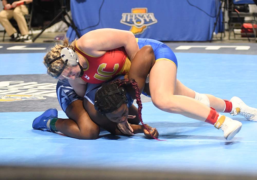 No. 1 Mallory Winner of Jay County High School runs a double-wrist bar on No. 11 Lydia Kwaleh of Perry Meridian during the inaugural IHSAA 170-pound state championship match at Corteva Coliseum at Indiana State Fairgrounds on Friday. Winner ended up pinning Kwaleh with the move at the 1:10 mark of the second period to secure her fourth state title and first sanctioned by the IHSAA. (The Commercial Review/Andrew Balko)