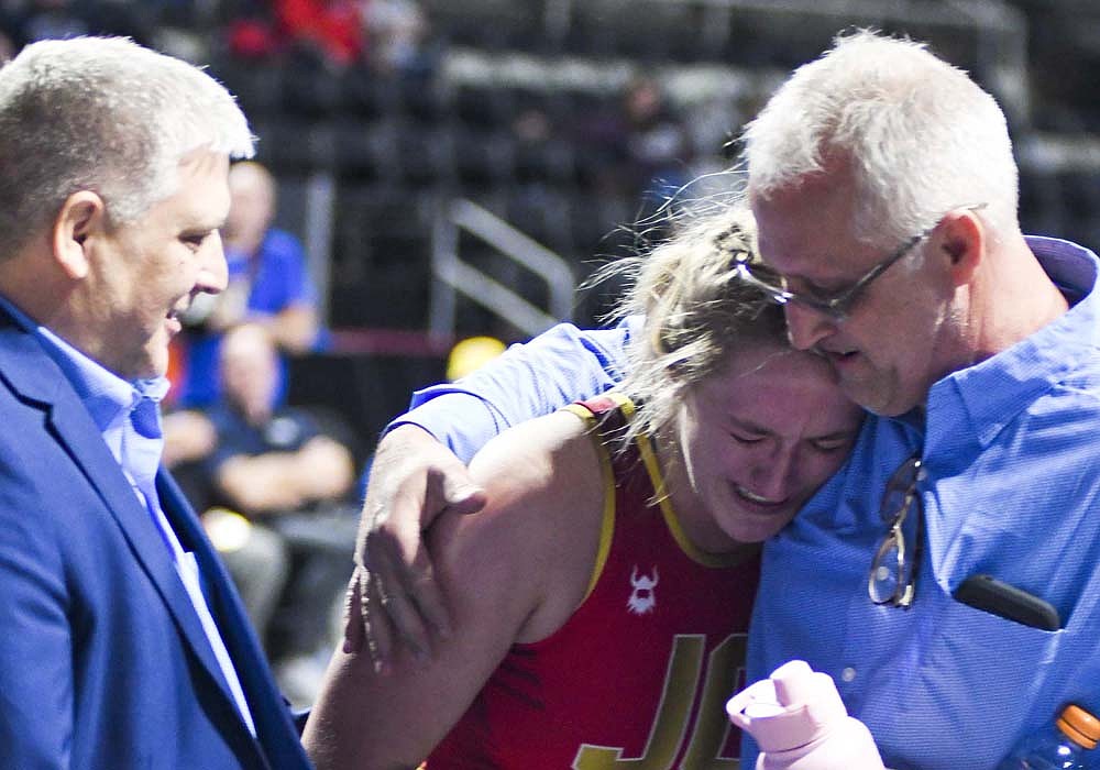 Jay County High School senior Mallory Winner tears up while hugging assistant coach and father Jon Winner following the inaugural IHSAA 170-pound state championship match on Friday at Corteva Coliseum at Indiana State Fairgrounds. No. 1 Winner pinned No. 11 Lydia Kwaleh of Perry Meridian after 2 minutes, 50 seconds, in a rematch of the regional title a week prior. (The Commercial Review/Andrew Balko)