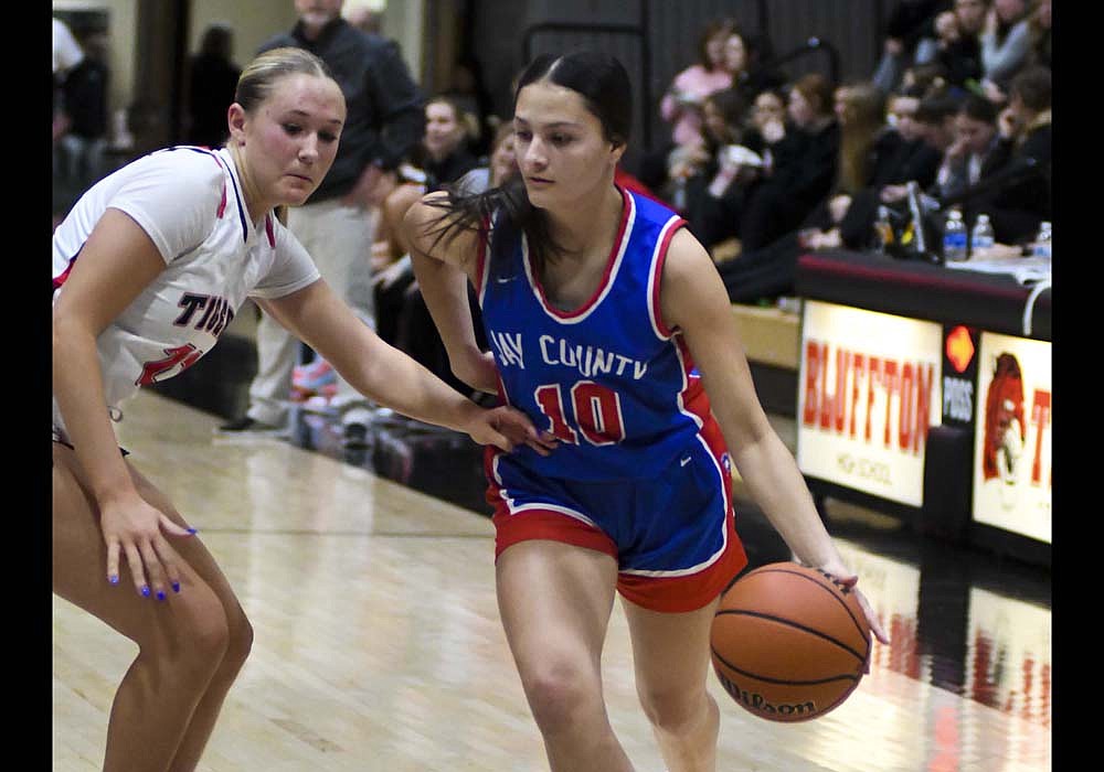 Jay County High School junior Raylah Newton dribbles against Isabella Stout of Bluffton during the second half Friday. Newton’s eight points were the team high for the Patriots, who fell out of the Allen County Athletic Conference Tournament with a 71-24 semifinal loss to the Tigers. (The Commercial Review/Ray Cooney)