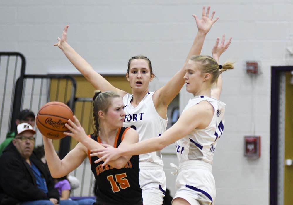 Karlie Niekamp and Kennedy Muhlenkamp of Fort Recovery High School swarm Bradford's Hayven Evans during the first half of the Indians' 61-22 victory Saturday morning. Niekamp totaled 24 points and Muhlenkamp had 16 for the Tribe, which forced 20 first-half turnovers. (The Commercial Review/Ray Cooney)