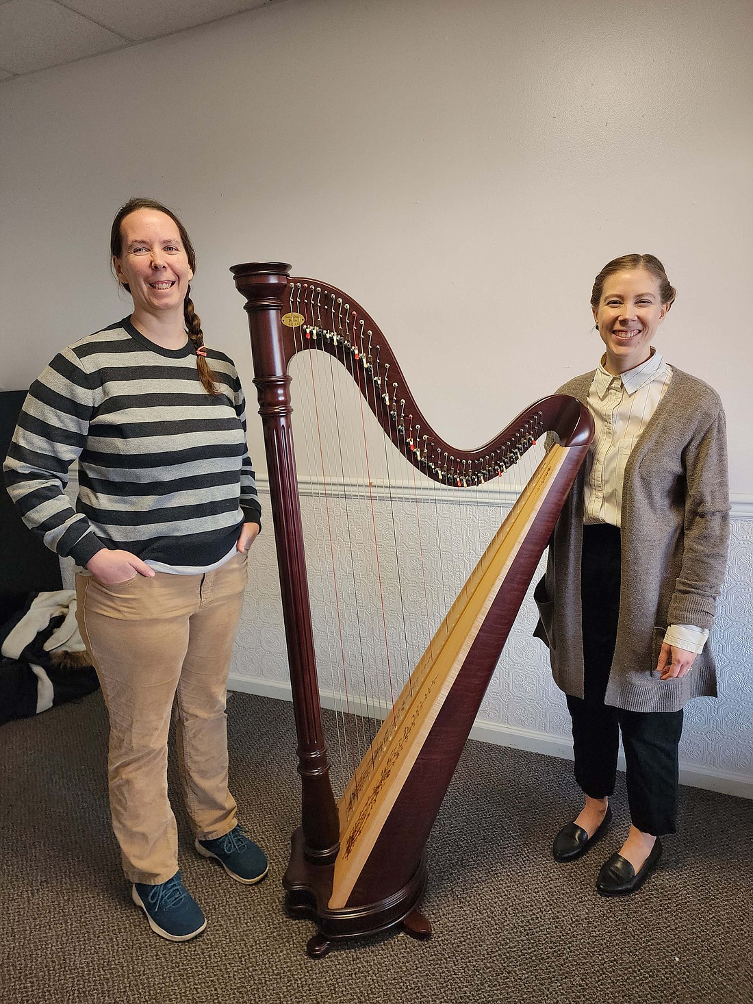 Cassie Glass, pictured above at left with instructor Kathryn Fenstermacher, recently became the first recipient of the Doctor Jennifer Hammond Clamme Memorial Scholarship at Arts Place. The new scholarship, started by Clamme’s family in her memory to encourage participation in the arts, will be awarded annually to a MusicWorks student receiving instruction at Arts Place Blackford County Arts Center. Glass is studying harp this semester at Arts Place. (Photo provided)