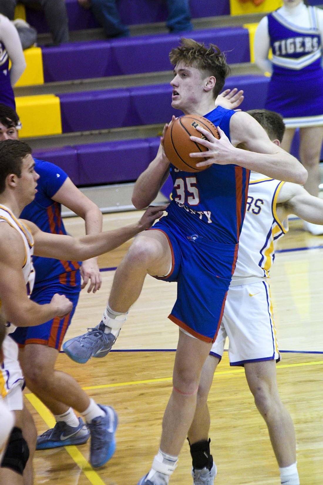 Jay County High School’s Gradin Swoveland clings to possession of the ball on Tuesday’s matchup against Hagerstown. The Patriots went on the road and overcame an early double-digit deficit to defeat the Tigers 56-49.  (The Commercial Review/Will Cash)