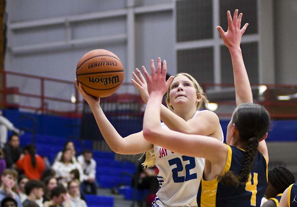 Jay County High School's Gabi Petro goes up for a shot against Olivia Marshall of Delta during the Patriots' 64-33 loss Thursday. JCHS will be back in action Saturday at Southern Wells. (The Commercial Review/Ray Cooney)