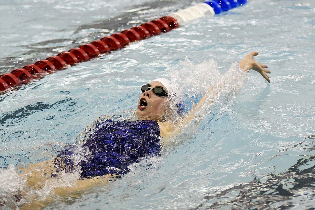 Maisey Keller of host Jay County High School swims the backstroke leg of the 200-yard individual medley Friday during the Allen County Athletic Conference Championships. Keller finished seventh in the race as she helped the Patriot girls to a runner-up finish behind South Adams. (The Commercial Review/Ray Cooney)