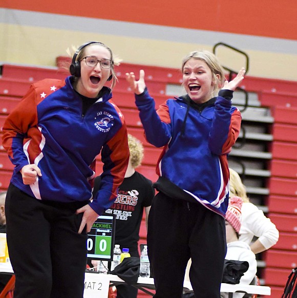 Mallory Winner (left) and Brenna Ruble of the No. 4 Jay County High School girls wrestling team burst with excitement as No. 5 Amara Crawford pinned No. 9 Brylee Blackwell of Mooresville to pull off a 47-30 upset and guarantee a top-four placement at the IHSGWCA Girls Team State Duals on Saturday hosted by Fishers. For the full story, see page 8. (The Commercial Review/Andrew Balko)