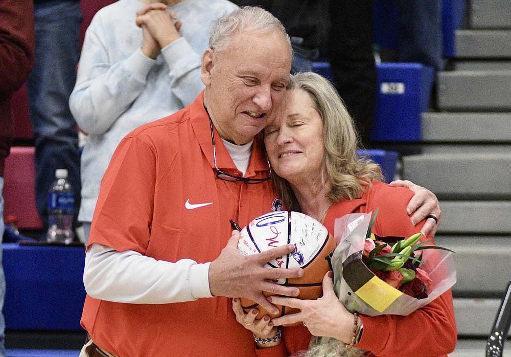 Jay County High School boys basketball coach Jerry Bomholt shares a moment with his wife Dede before Friday night’s game against the Bluffton Tigers. Bomholt was presented with a ball commemorating his 600th career win and honored with a standing ovation. He earned win No. 600 on Jan. 14 against South Adams in the Allen County Athletic Conference Tournament. Friday’s game was the first at home for the Patriots since then. (The Commercial Review/Ray Cooney)