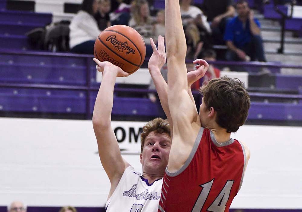 Colson Post of the Fort Recovery High School boys basketball team takes contact from New Knoxville’s Solly Stiles as he converts a 3-point play during Friday’s 61-53 win for the Tribe. (The Commercial Review/Andrew Balko)