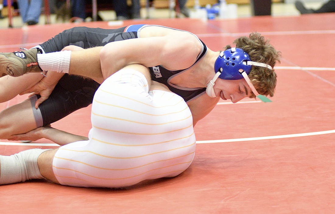 Jay County High School's A.J. Heskett hits a cradle against Wyatt Mann of South Adams during their 144-pound sectional championship match Saturday. Heskett rolled to a 17-1 win by technical fall, picking up one of the two individual titles for the host Patriots. (The Commercial Review/Ray Cooney)