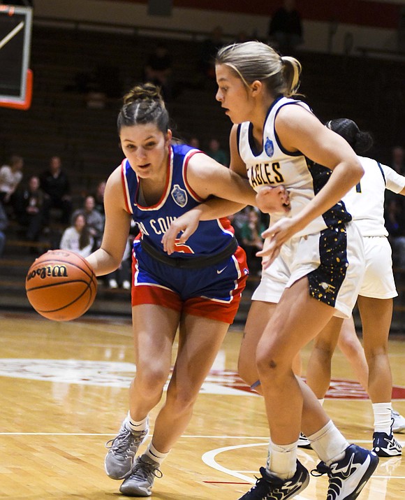 Jay County’s Alexis Sibray drives on Griffyn Knight of Delta during the the Patriots’ 59-38 loss in the IHSAA Sectional 24 semifinal at Connersville on Friday. The Patriots’ season came to a close with a 10-13 record, which is the first time they finished below .500 since the 2013-14 season. (The Commercial Review/Andrew Balko)