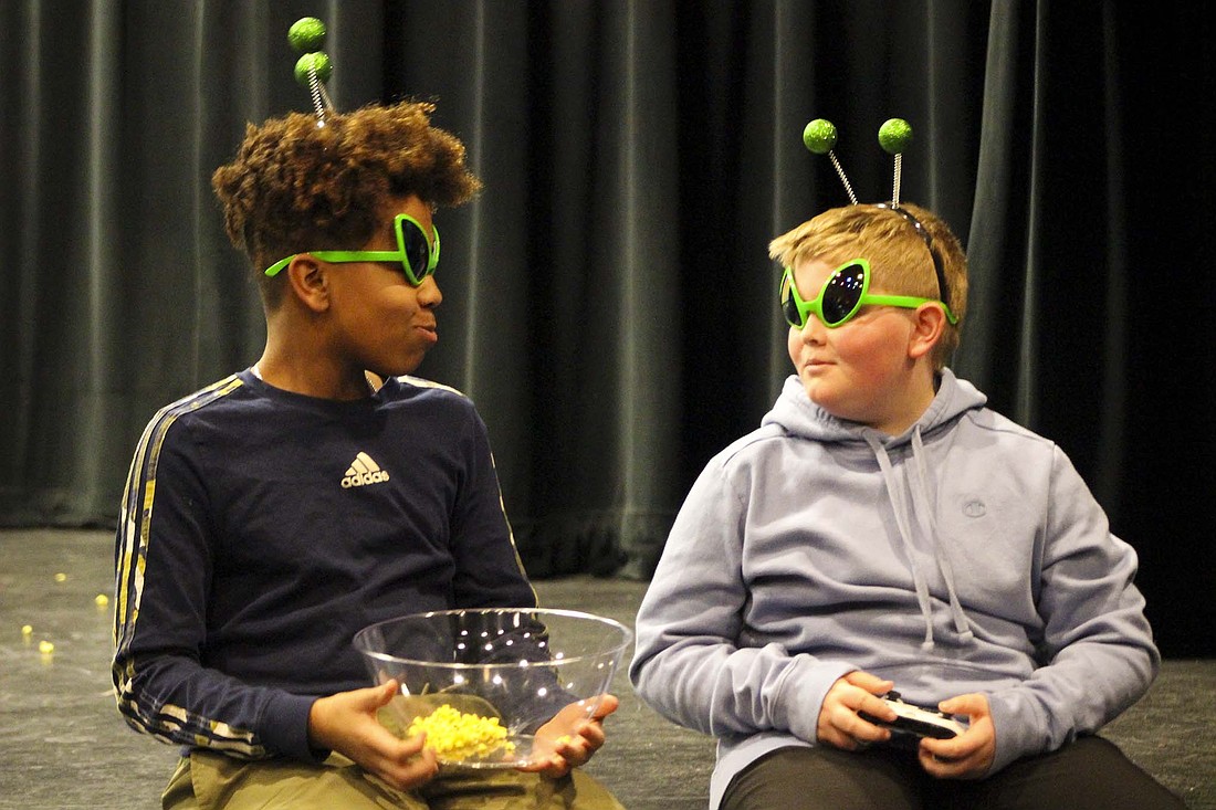 A couple of aliens played by Titus Schwieterman (left) and Drew Lingo share some popcorn on stage during rehearsal last week for Jay County Civic Theatre’s production of “Everyone Gets Abducted By Aliens: A Cautionary Tale.” The show opens with a performance at 7 p.m. Thursday at the Jay County Campus of Arts Place in Portland. Additional shows are scheduled for 7 p.m. Saturday and 2 p.m. Sunday. (The Commercial Review/Bailey Cline)