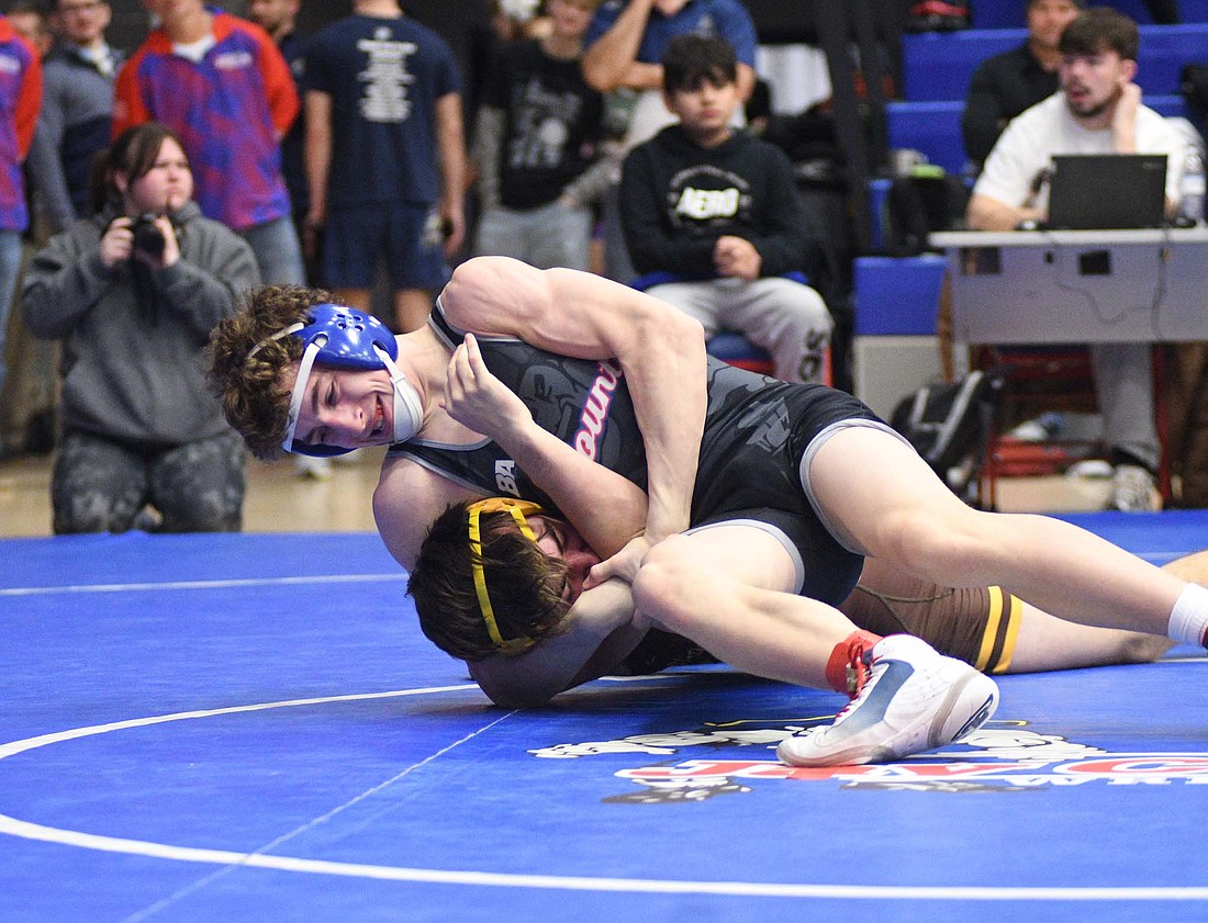 A.J. Heskett of the JCHS boys wrestling team runs a headlock on Monroe Central’s Cory Brown Jr. during the 144-pound opener at the IHSAA Regional meet hosted by the Patriots on Feb. 8. Heskett will open the semi-state against Erik Hunt of Western on Saturday. (The Commercial Review/Ray Cooney)