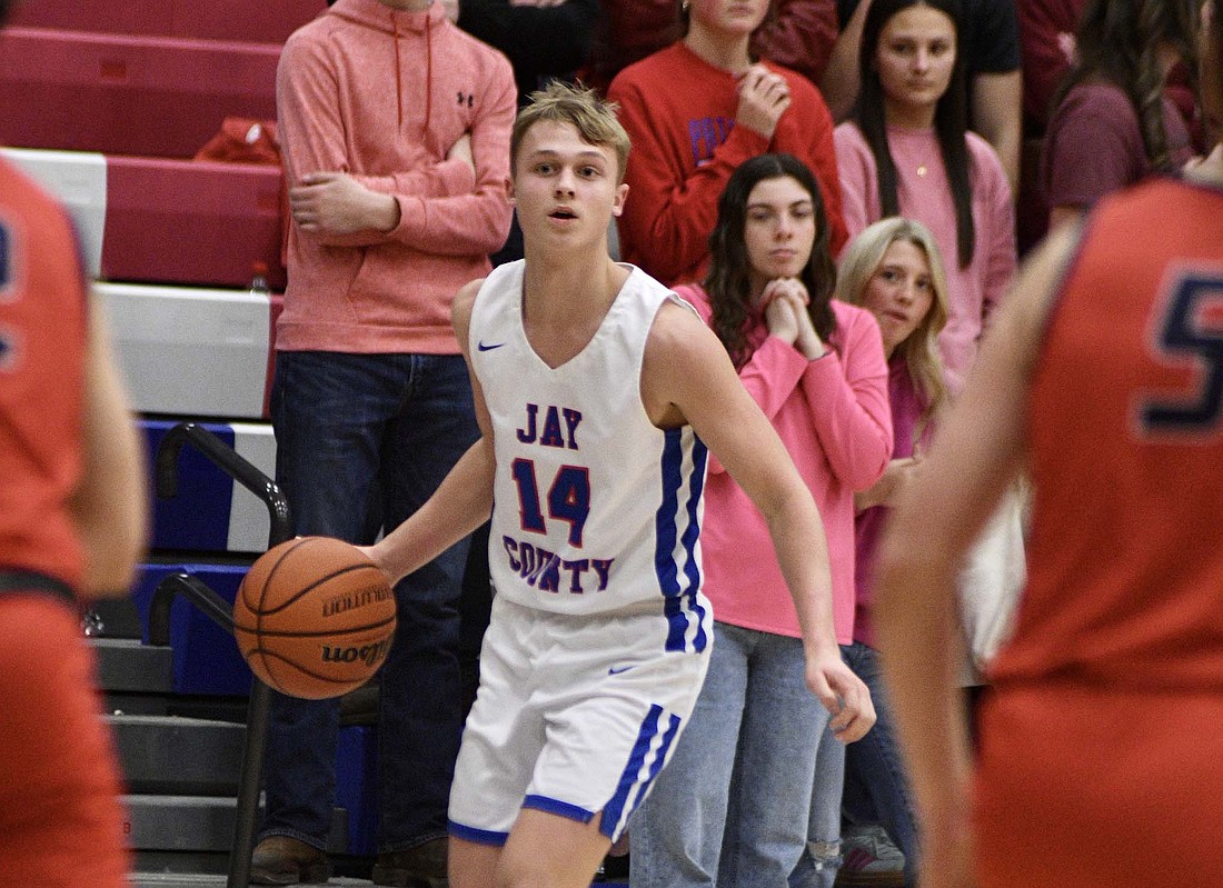 Jay County High School sophomore Benson Barnett looks for space to create offense between a pair of Heritage defenders during the fourth quarter Friday. Barnett hit a 3-pointer as the Patriots rallied from a double-digit deficit only to fall to the visiting Patriots by one and slip to 3-3 in the Allen County Athletic Conference. (The Commercial Review/Ray Cooney)