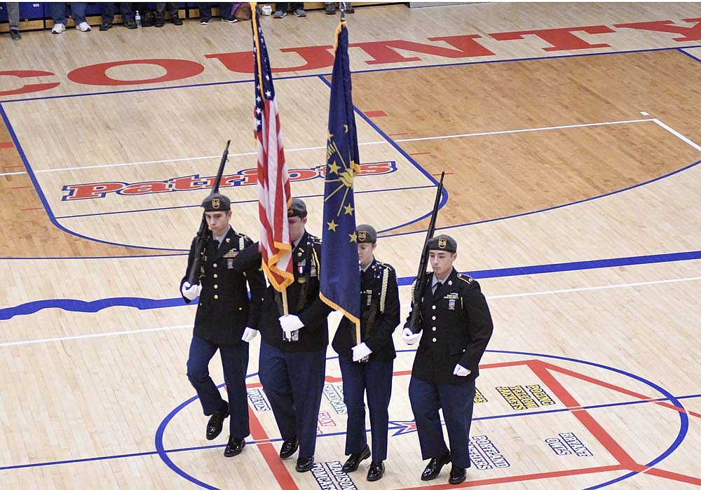 Jay County Junior-Senior High School JROTC members presented the colors for the playing of the national anthem Friday night before the Patriots’ boys basketball game against Heritage. (The Commercial Review/Ray Cooney)