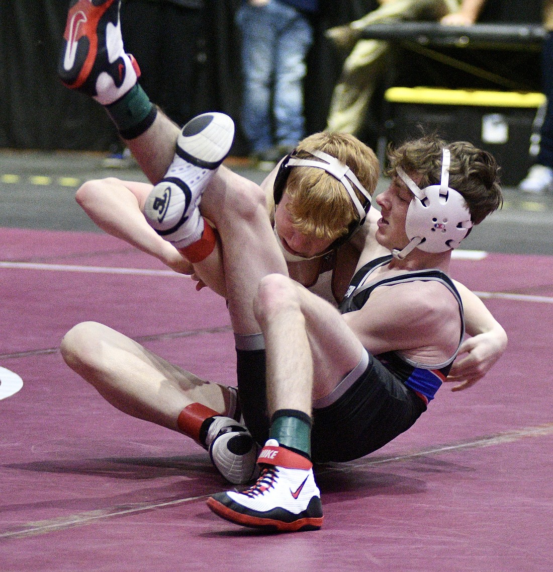 Jay County High School senior Griffin Byrum tries to lock Charlie Fleshman (39-2) of Central Noble into a cradle during their quarterfinal match in Saturday’s semi-state tournament at Allen County War Memorial Coliseum in Fort Wayne. Byrum, who was ranked 16th at 113 pounds, lost by pin to Fleshman in the second period. He finished his  senior season at 36-5. (The Commercial Review/Ray Cooney)