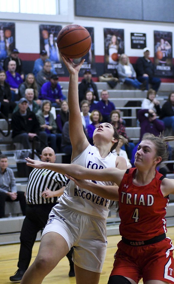 Madie Schoenlein takes a transition layup while April Hillman of Triad contests during Saturday’s OHSAA Division VI Southwest 2 sectional championship at Covington. The Indians came out on top 48-19 to secure their first playoff win in three seasons. (The Commercial Review/Andrew Balko)