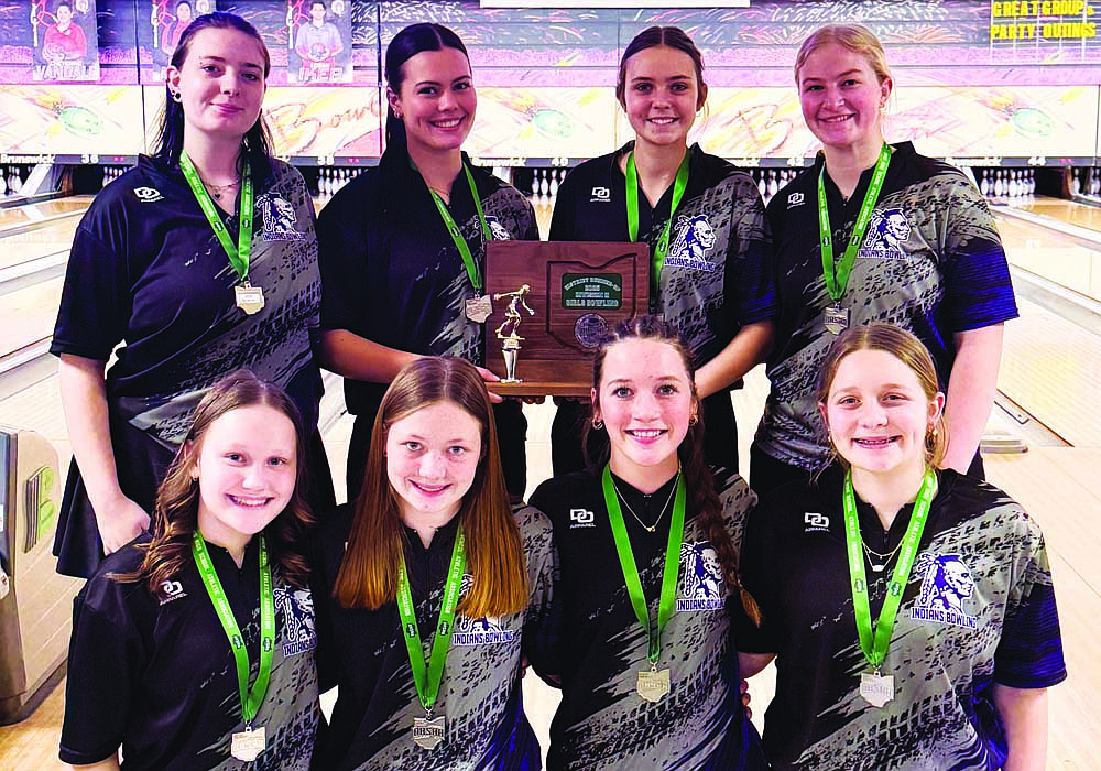 The Fort Recovery High School girls bowling team poses with the OHSAA Division II Southwest District runner-up trophy at Beaver-Vu Bowl on Wednesday after clinching their second trip to the state tournament. First row from left to right are Lilah Thien, Deanna Brown, Jadyn Wyerick and Maddie Weigel. Back row are Saidy DeRoo, Kayla Heitkamp, Emily Lauber and Ella Schoen. (The Commercial Review/Andrew Balko)