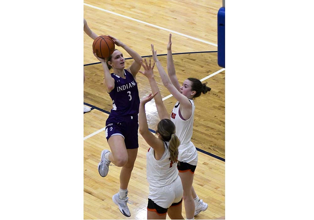 FRHS senior Karlie Niekamp rises up for a shot while a pair of Arcanum defenders contest during Saturday’s 44-25 loss in the OHSAA Division VI Southwest 2 District Championship at Monroe. Niekamp led Fort Recovery with 10 points and eight rebounds. (The Commercial Review/Andrew Balko)