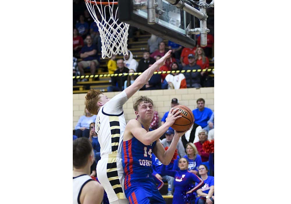 Jay County High School sophomore Benson Barnett draws a foul on Caleb Hummel of Winchester at the tail end of a press break. The Patriots hung on to win the game 68-57 after Winchester shaved a 19-point deficit to only six midway through the fourth quarter. (The Commercial Review/Andrew Balko)