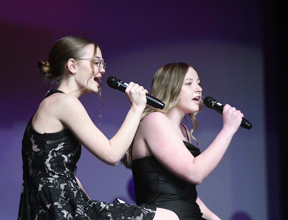 Ally Roessner and Madeline Hardwick sing Elvis Presley’s “Can’t Help Falling in Love” during the Fort Recovery junior high and high school cabaret concert on Sunday evening. (The Commercial Review/Ray Cooney)