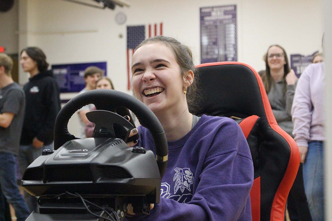 Fort Recovery High School sophomore Cameron Muhlenkamp, 16, laughs after crashing a car in a simulation Friday during the Save A Life Tour impaired and distracted driving prevention program in the gymnasium. (The Commercial Review/Bailey Cline)