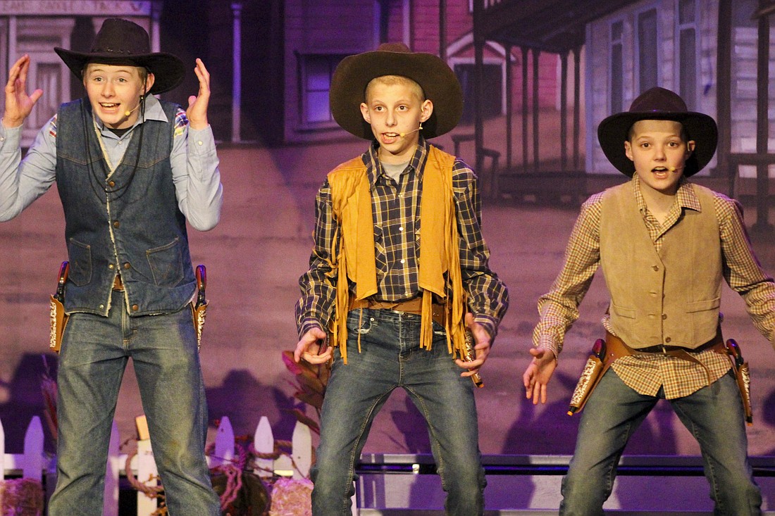Bandits (above) in Fort Recovery Elementary/Middle School’s production of “Wagon Wheels West” take the stage Tuesday during dress rehearsal. Students performing as bandits in the show include Korbin Wuebker as Straight Shooting Sam, Logan Gaerke as Dallas, Gavin Gaerke as Cisco Kid and AJ Roessner as Arizona Kid. Below, saloon girls and Anna Niekamp (right) as Sue Flay perform “Anything Can Happen.” Performances are at 7 p.m. Friday and 2 p.m. Saturday and Sunday. (The Commercial Review/Bailey Cline)
