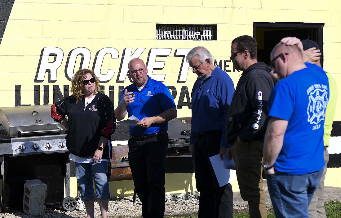 Portland Park Board president Brian Ison (center) gestures toward the planned location for a new storage building at Portland Memorial Park’s Runkle-Miller Field during Tuesday’s annual park tour. Pictured with Ison, from left, are board member Shauna Runkle, Rockets supporter Randy Fisher and street and parks department superintendent Matt Shauver. (The Commercial Review/Ray Cooney)