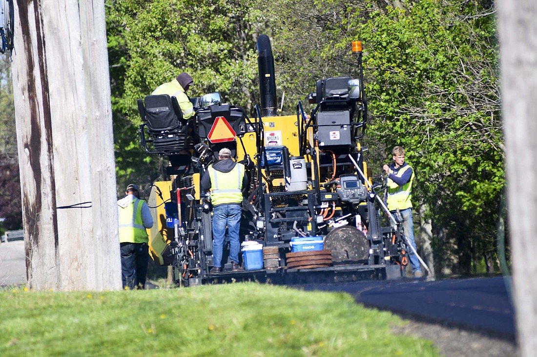 A crew from Brooks Construction works on paving Seventh Street on Wednesday morning. The work is part of a project that also includes paving sections of Franklin Street, Ship Street, Tyson Road, Western Avenue, Williams Street and Wayside Place. (The Commercial Review/Ray Cooney)