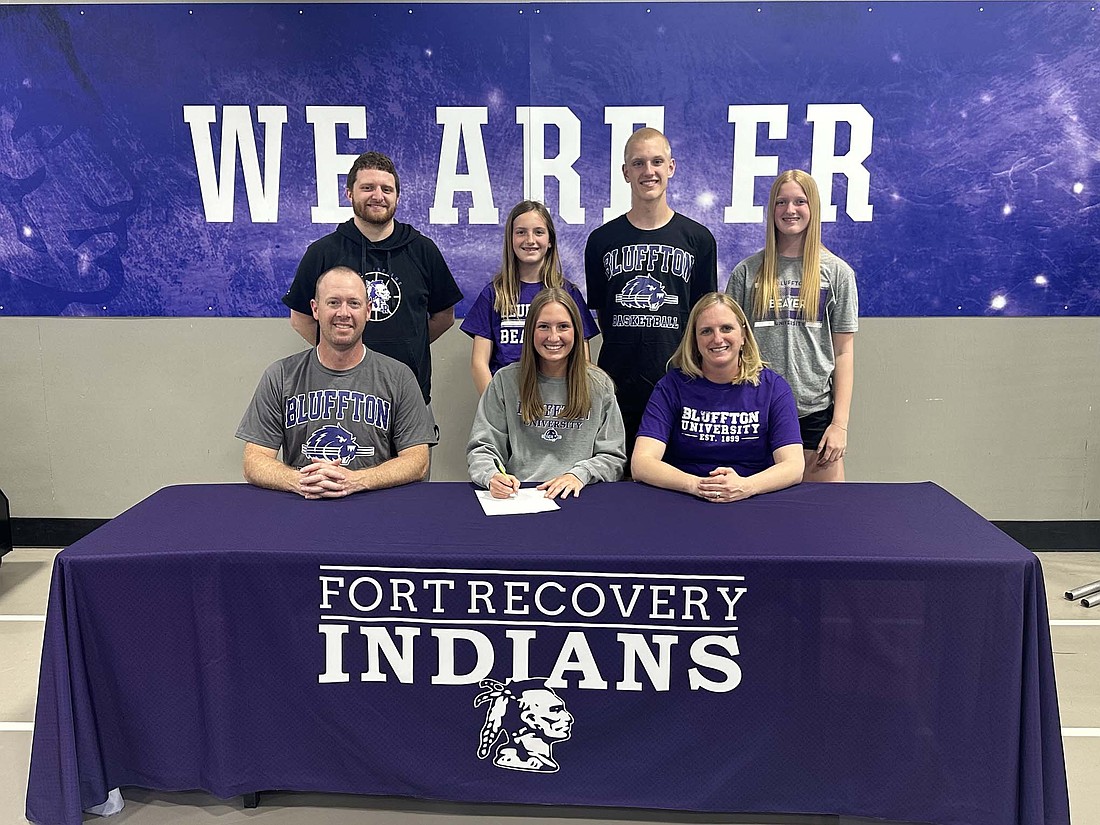 Karlie Niekamp signed her letter of intent Monday to play basketball at Bluffton University. Pictured in the first row from right are father and assistant coach Brent Niekamp, Karlie and mother Kim Niekamp. Back row are Fort Recovery High School girls basketball coach Tyler Deitsch and siblings Audrey Niekamp, Andy Niekamp and Ellie Niekamp. (Photo provided)