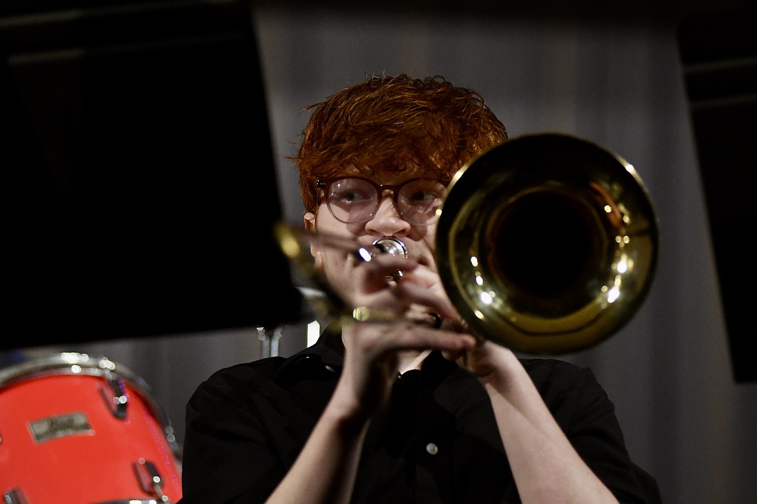 The Jay County High School band and Fort Recovery’s junior high and high school choirs held their spring concerts Sunday. Pictured above, trombone player Caleb Roesch plays during the JCHS jazz band performance. Below, Trinity Rammel dances with the FRHS choir during its performance of “We Built This City” by Starship. (The Commercial Review/Ray Cooney)