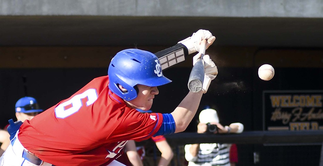 Wyatt Foster, the No. 2 hitter in the Jay County High School baseball team’s lineup, gets low as he tries to lay down a bunt during Tuesday’s game at South Adams. Foster drew a walk in the at bat to drive in a run. The Patriots beat the Starfires 11-0 to pick up their second Allen County Athletic Conference of the season. (The Commercial Review/Andrew Balko)