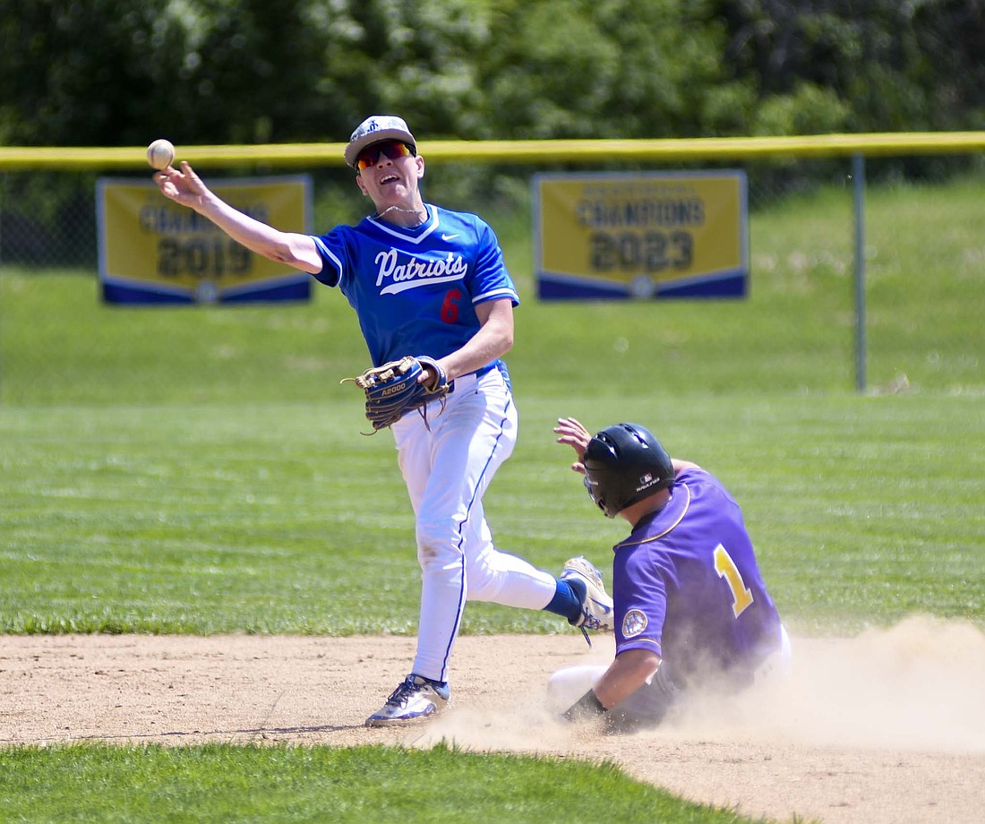 Jay County High School sophomore Wyatt Foster spins to try and turn a double play during the second game of a doubleheader against Hagerstown on Saturday. The Patriots opened the day with a 6-2 victory before falling 7-4 later in the day. (The Commercial Review/Ray Cooney)
