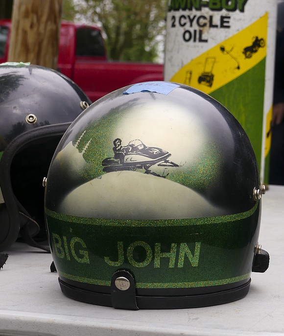 In addition to the bicycles, John Deere also manufactured helmets. Mike Watson owns three helmets made by John Deere and one custom-made "Big John" helmet. (The Commercial Review/Lindy Mercer)