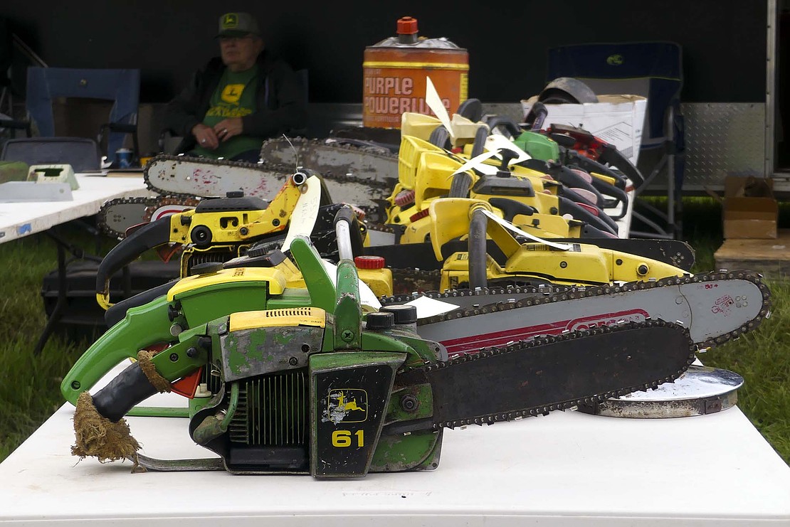 John Deere has manufactured several different chainsaw models since the 1930s, and Mike Watson is the owner of 20 different models. These vintage chainsaws are just a fraction of Watson's impressive John Deere collection. (The Commercial Review/Lindy Mercer)