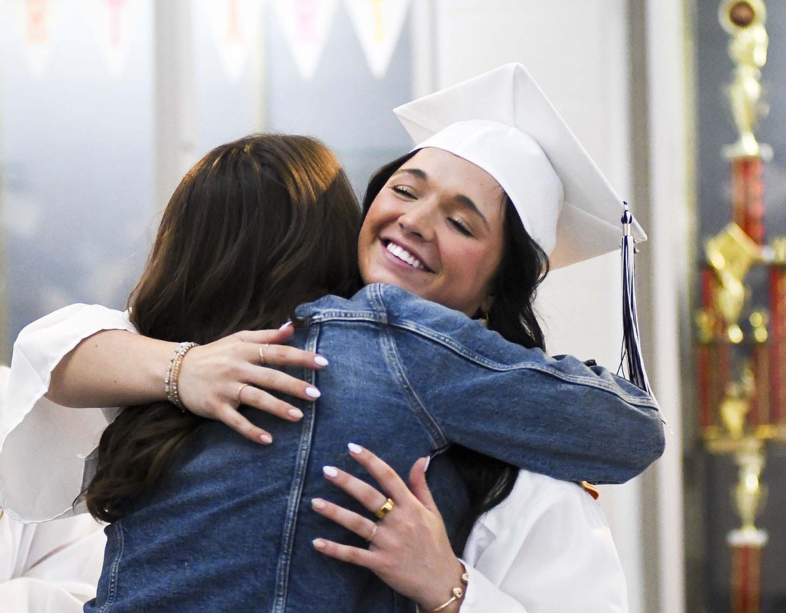 Mara Wenning gets a hug following Fort Recovery High School’s graduation ceremony Sunday afternoon. FRHS said goodbye to 77 graduates, with principal Ryan Steinbrunner encouraging them to take advantage and appreciate each “one more time” that comes along in their lives. (The Commercial Review/Ray Cooney)