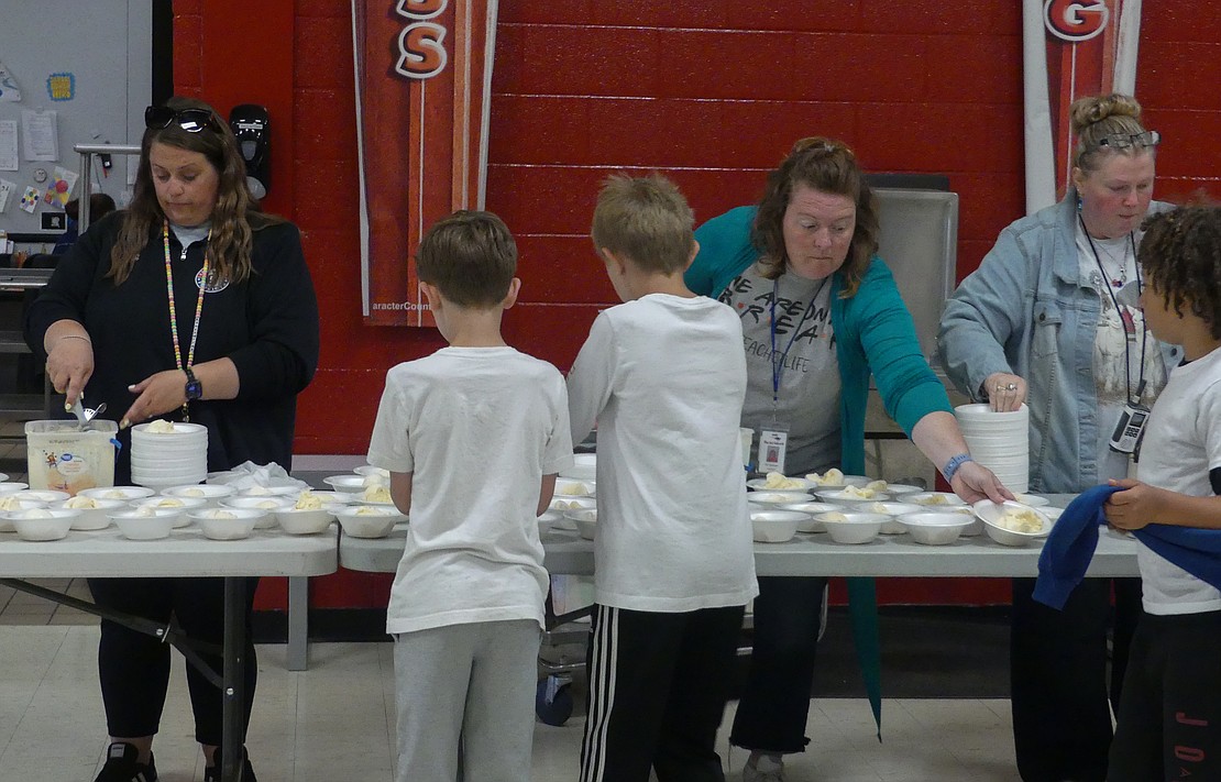 Heather Keller (left), Amy Hawbaker (center), and Julia Kable (right) scoop and serve ice cream as a part of Bloomfield Elementary's last day of school celebration on Friday. Keller is Bllomfield's art teacher, Hawbaker is Bloomfield's librarian, and Kable is Bloomfield's ESL teacher. (Lindy Mercer)